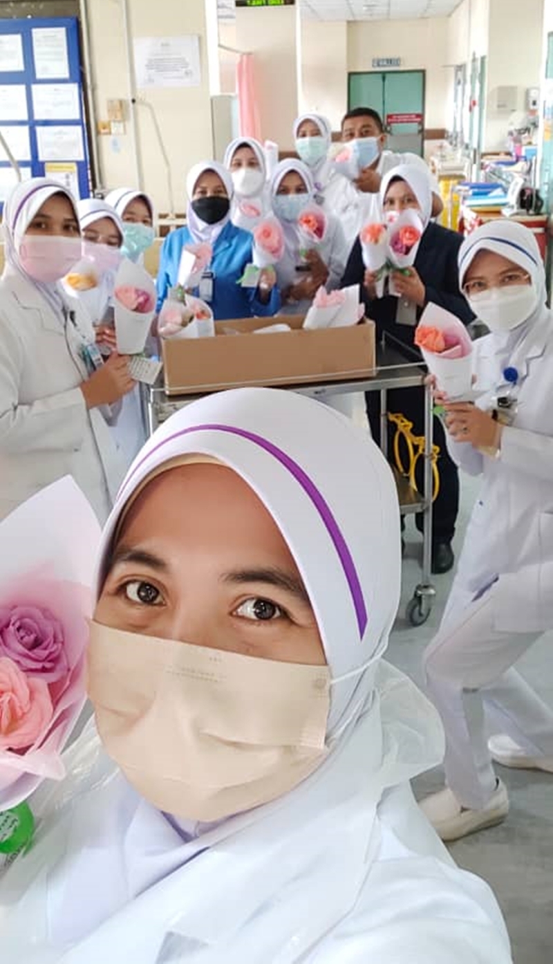 病房内的护士们收到鲜花后，拍照分享他们的喜悦。