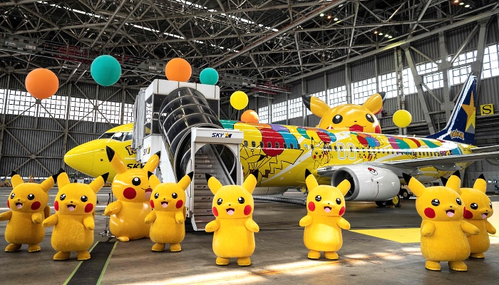 Pikachu mascots standing beside a Skymark Airlines Boeing 737-800 aircraft with its new Pokemon-themed livery in a hangar at Tokyo's Haneda International Airport during its unveiling on Monday. AFP