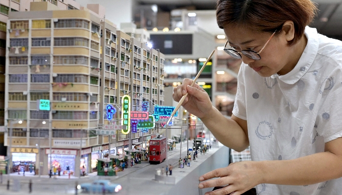 Model maker Maggie Chan of Toma Miniatures working at her studio in Hong Kong.  AFP