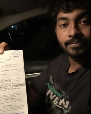 Vicneswara shows the summons he received as he was unable to complete all the orders before 8pm. Vicneswara shows the summons he received as he was unable to complete all the orders before 8pm.