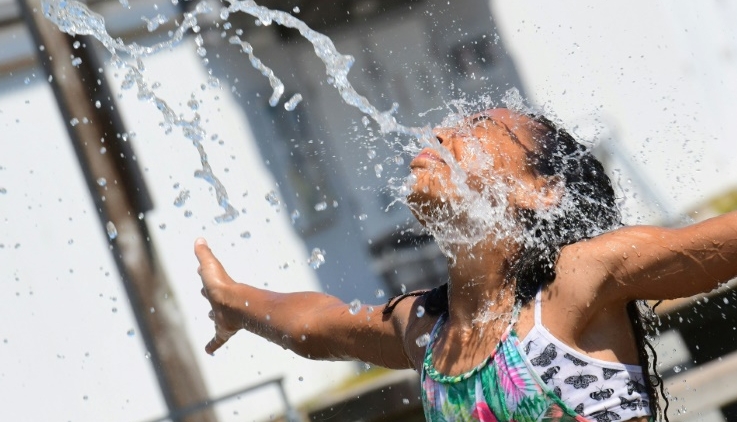 A child cools off at a community water park on a scorching hot day in Richmond, Canada. AFP A child cools off at a community water park on a scorching hot day in Richmond, Canada. AFP