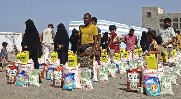 People displaced by conflict receive food aid in the Tuhayta district of Yemen's war-ravaged western province of Hodeida. AFP