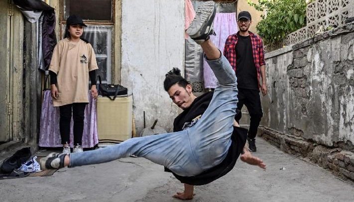 A group of breakdancers comprised of mostly Hazara boys looks on as a fellow troupe member breaks a move in Kabul. AFP
