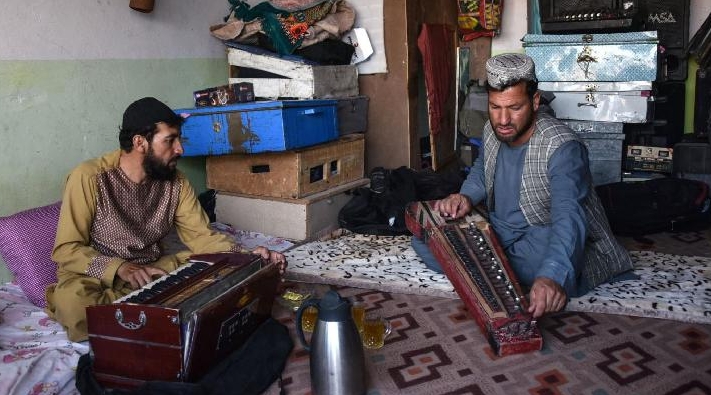 Sayed Mohammad (R) rehearses with his japani, a traditional Central Asian stringed instrument at his music studio in Kandahar. AFP