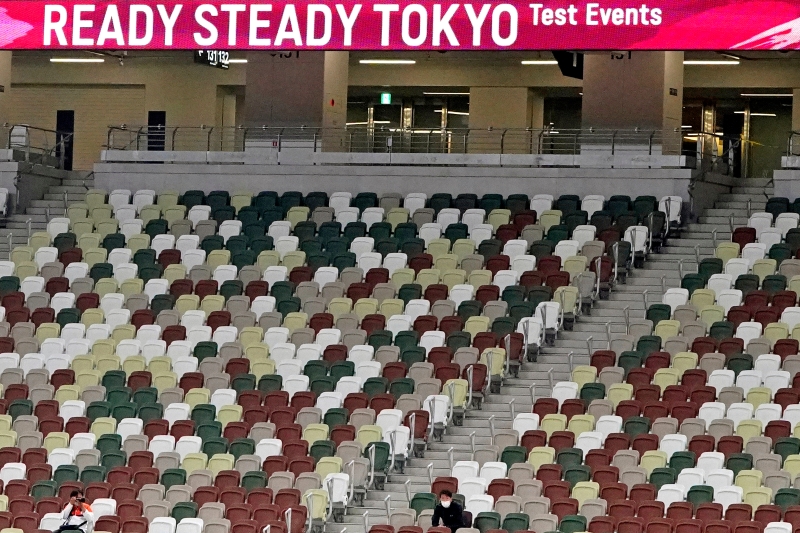 日本近日冠病疫情反弹，日本政府消息称7月23日的东京奥运开幕仪式或将呈无观众场面。图为东京国立竞技场5月9日举行的奥运田径测试赛，只有两名男子在现场观看。（图：美联社）