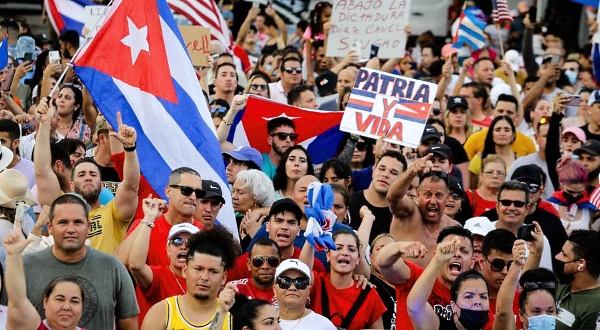 People demonstrate, some holding Cuban and US flags and placards, during a protest against the Cuban government in Miami. AFP
