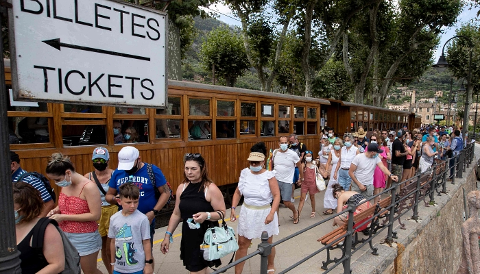 Passengers arrive to ride the Palma-Soller train in Soller in the Spanish Balearic Island of Mallorca. AFP