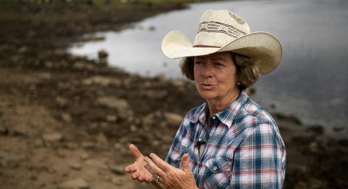 Cattle rancher Janie VanWinkle, seen standing near a reservoir on her Colorado ranch during a record-hot summer, says drought is only one problem facing fellow ranchers. AFP