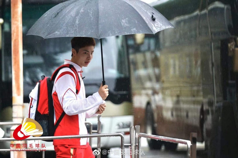中国男单石宇奇在在雨中从北京运动员公寓出发前往日本参加东京奥运会。（中国羽球队微博照片）