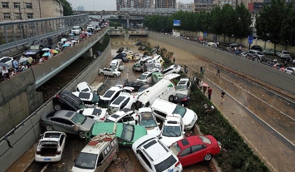 Cars were strewn over roads after the heavy rains hit the city of Zhengzhou AFP