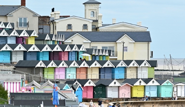 Brightly painted wooden beach huts along England's coastline have enjoyed a boom during the pandemic. AFP
