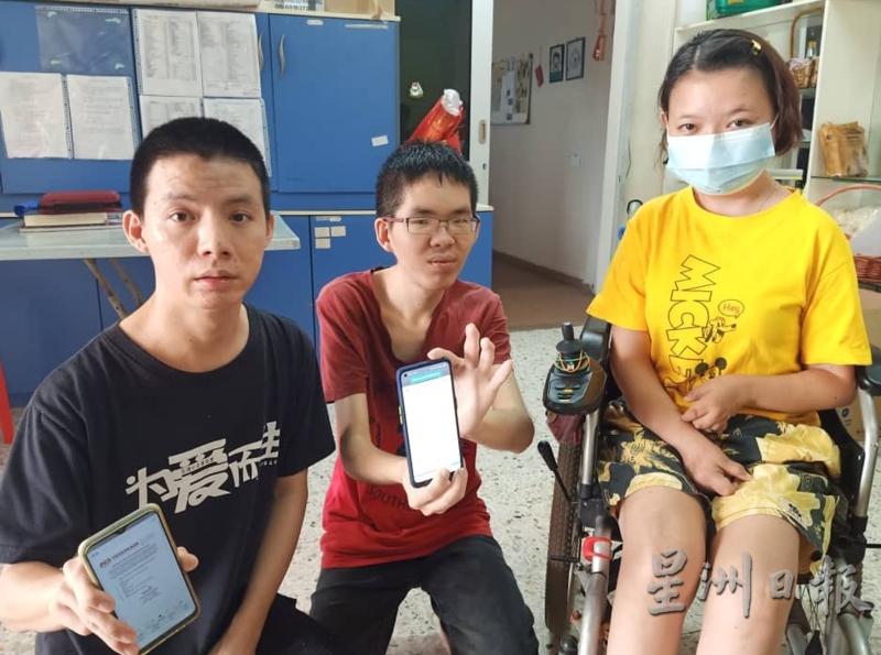 伍依宁（右）与其他两名同样在援助计划下受惠的残障朋友，出示他们手机内显示的100令吉。