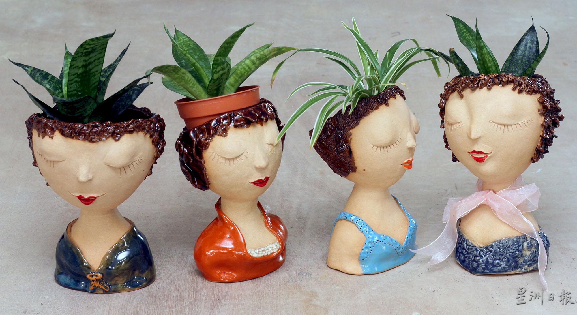 人像陶艺的头部设计成可以充作花盆，置放绿色植物，美观又实用。

