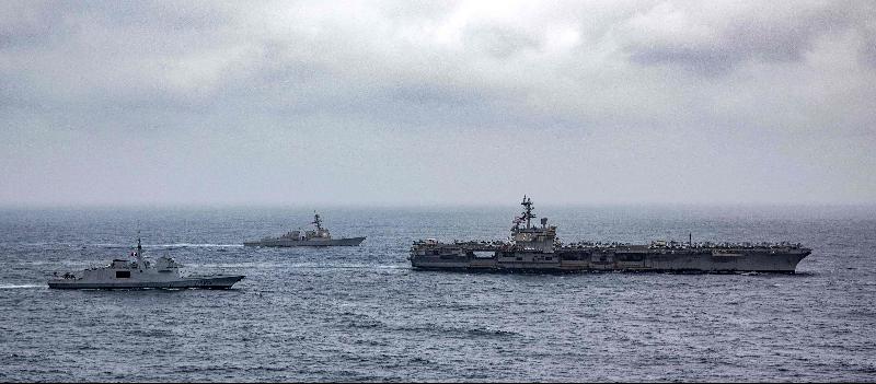 美国海军释出的照片显示，护卫舰“朗格多克”号（左起）丶美国“哈尔西”号驱逐舰与“里根”号航母在阿拉伯海共同编队航行。（图：法新社）