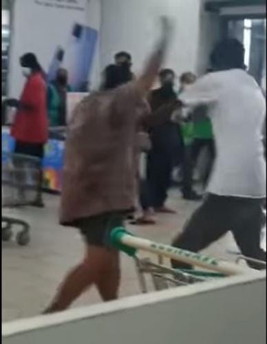 保安人员阻止一名没戴口罩的妇女进入超市，结果两方不满起争执，还一度互相殴打。