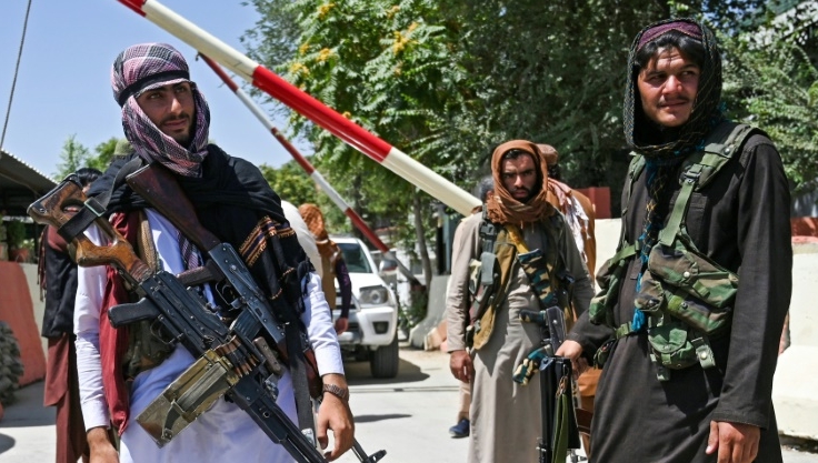Taliban fighters stand guard on a road near Zanbaq Square in Kabul. AFP