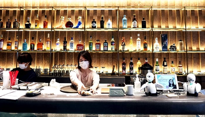 Miniature humanoid robots named OriHime at the Dawn Cafe in Tokyo. AFP