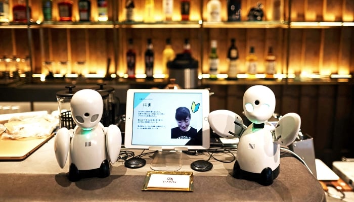 Miniature humanoid robots named OriHime at the Dawn Cafe in Tokyo. AFP